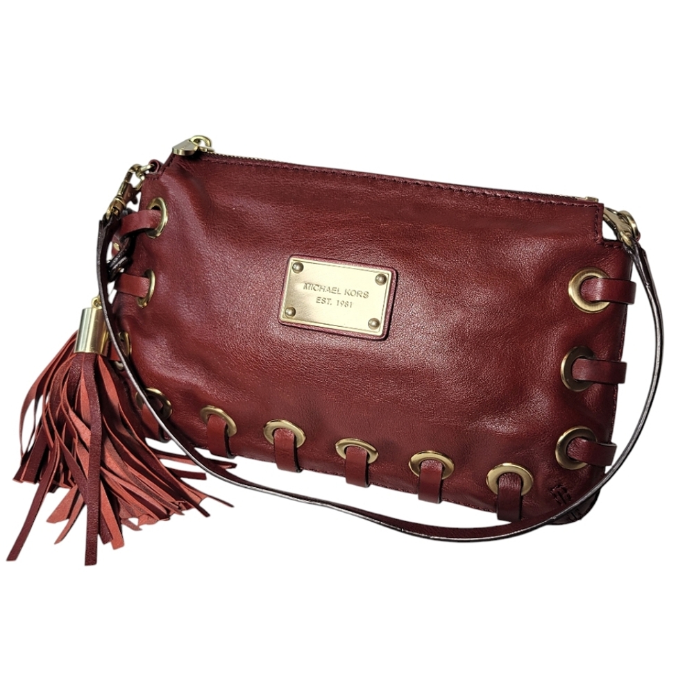 Michael Kors red leather clutch with grommets and tassels